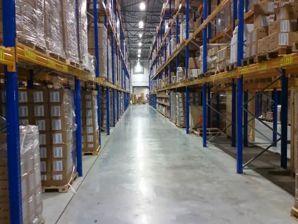 Long aisle of stacked storage boxes in a warehouse