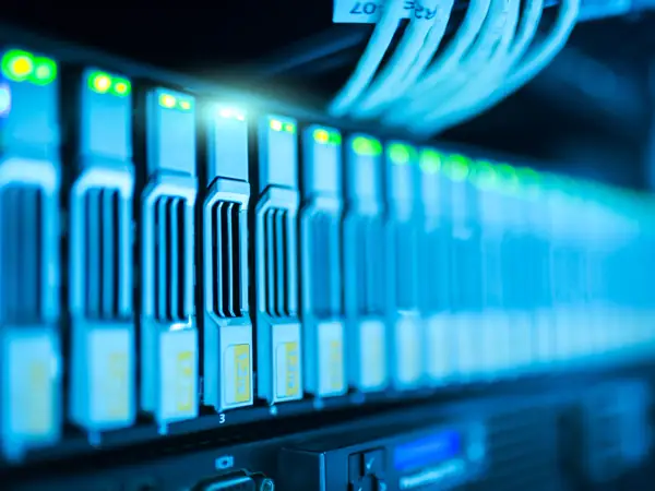 A server rack full of lit indicator lights